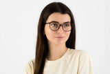 Woman wearing Serene Brown, Oval Brown Acetate Glasses