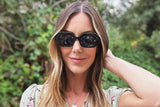 Woman wearing Mia Black, Black Octagon Geometric Sunglasses